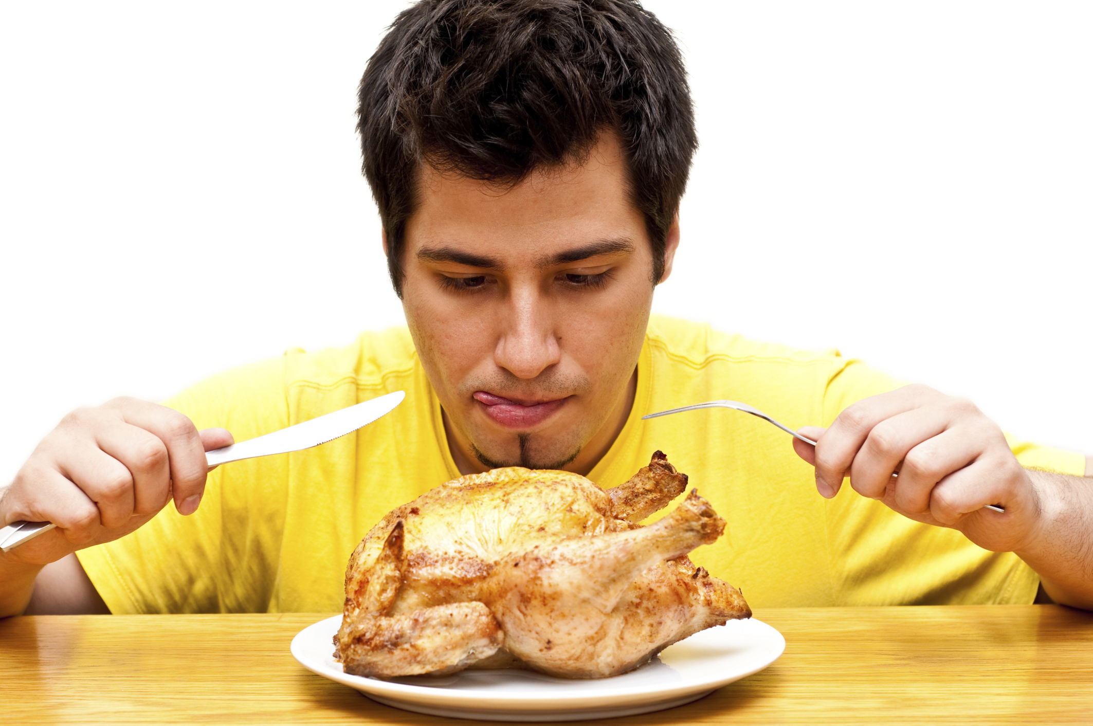 hungry young man waiting to eat freshly roasted whole chicken