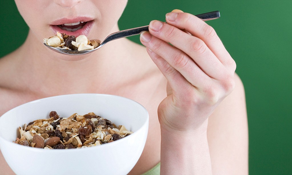 BCGNMM A woman eating muesli, close-up